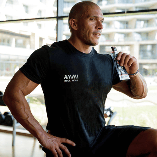 fitness instructor eats protein meat bar